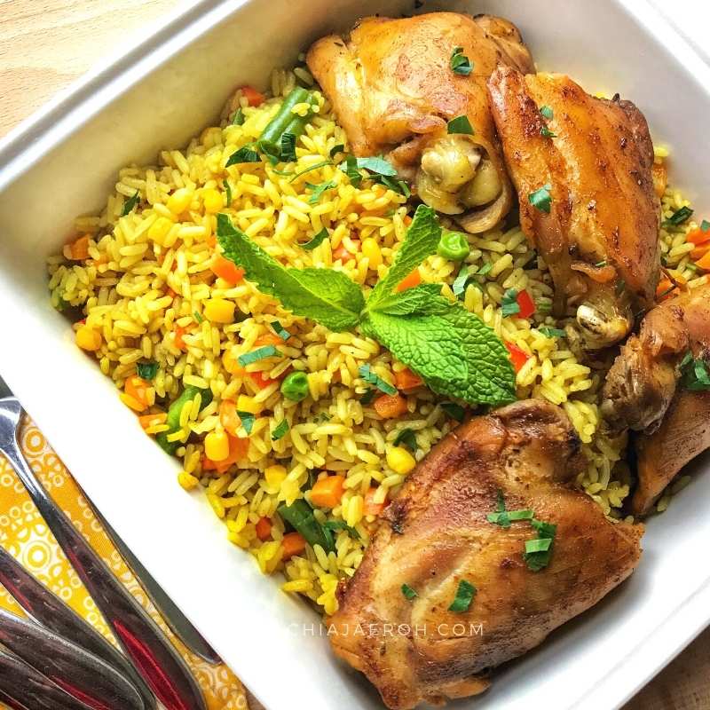Chef stirring a large pot of African rice